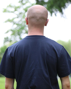 Théo de dos portant le t-shirt bleu Basics de Tous Imparfaits